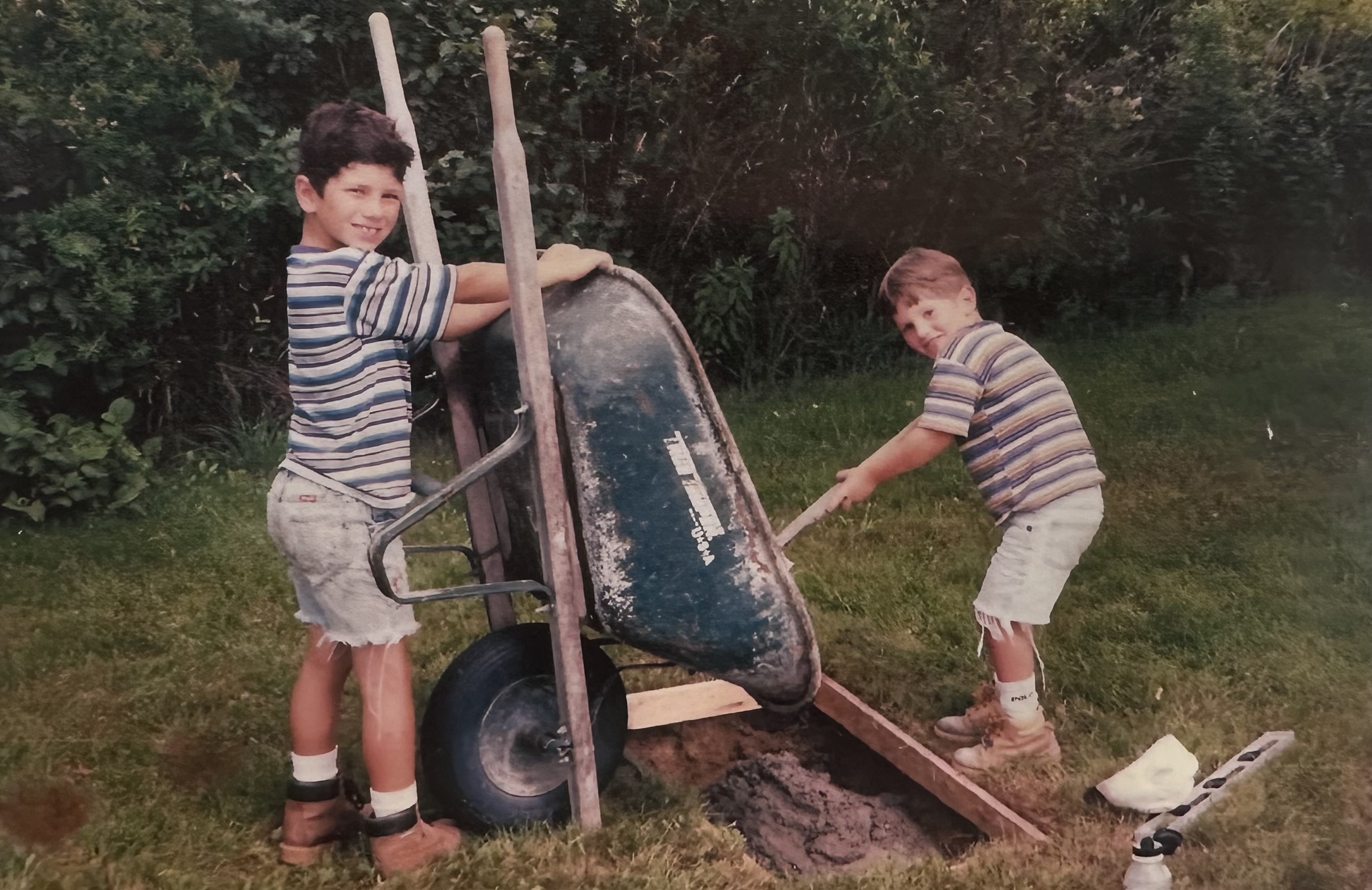 Jeff Pignona Jr. and Sawyer Pignona as children, pouring a monument foundation — the fourth generation on a job site