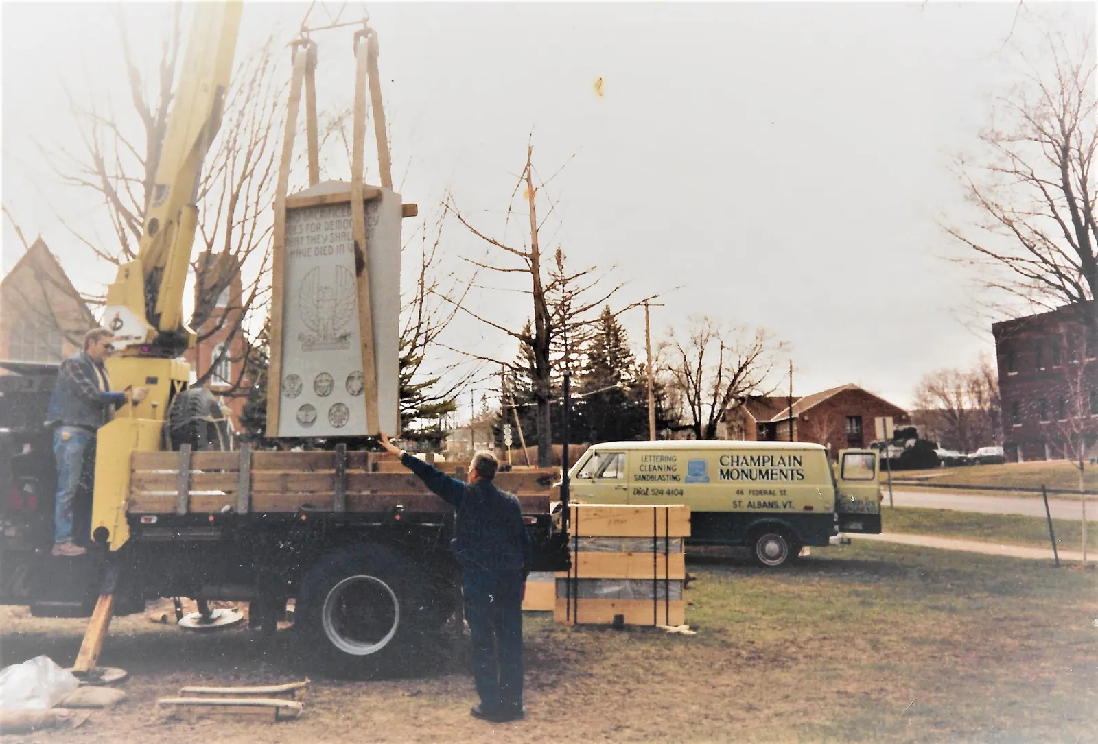 Champlain Monuments crane and van on a Swanton job site