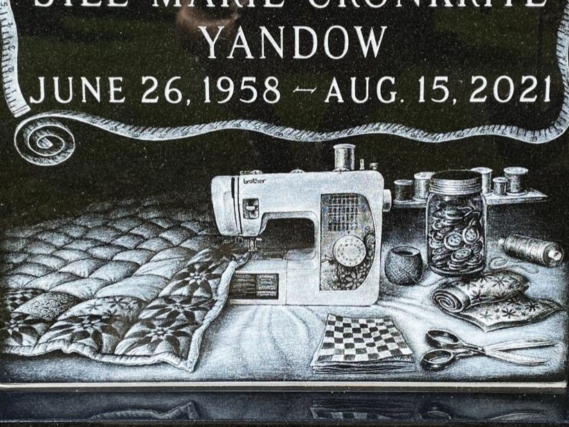 Custom hand-etched sewing scene on polished black granite