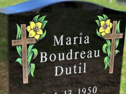 Hand-etched cross with flowers on polished black granite