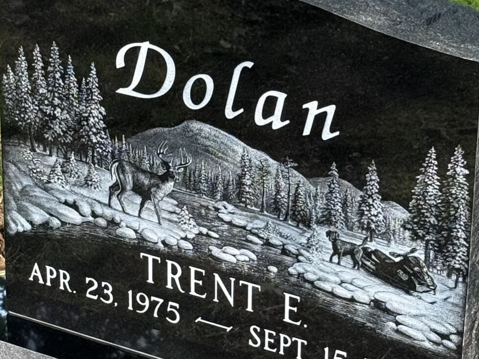 Hand-etched winter scene on polished black granite