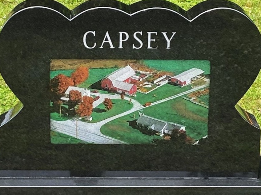 Laser-etched color farm scene on polished black granite