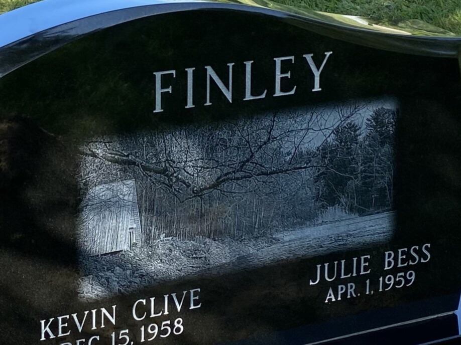 Laser-etched woods scene on polished black granite