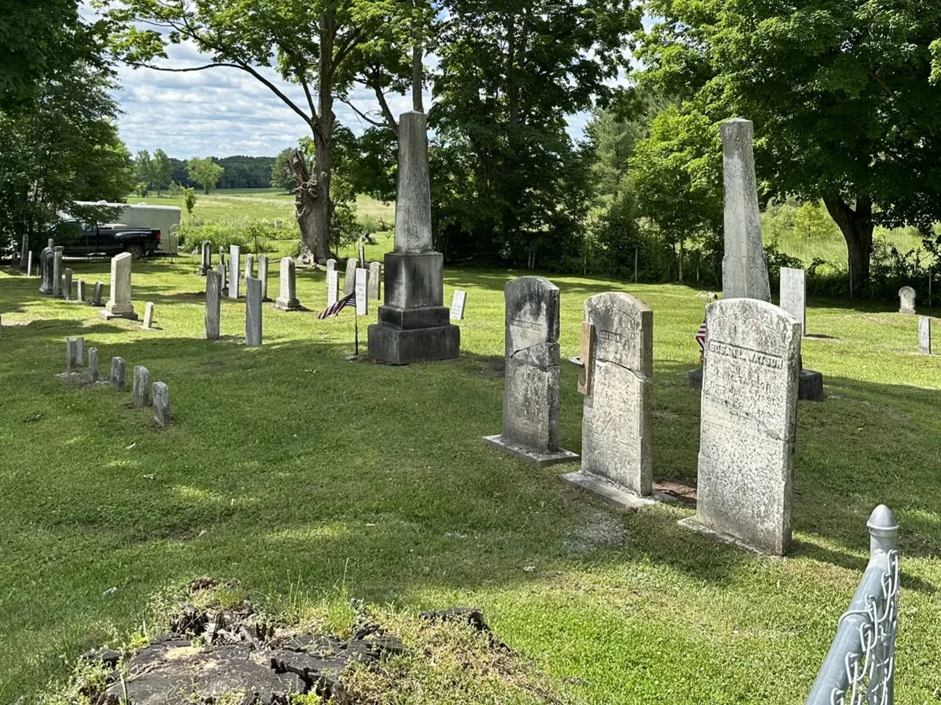 A leaning slab memorial being straightened and restabilized